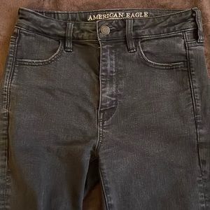 Black high waisted American eagle skinny jeans with rips in both knees